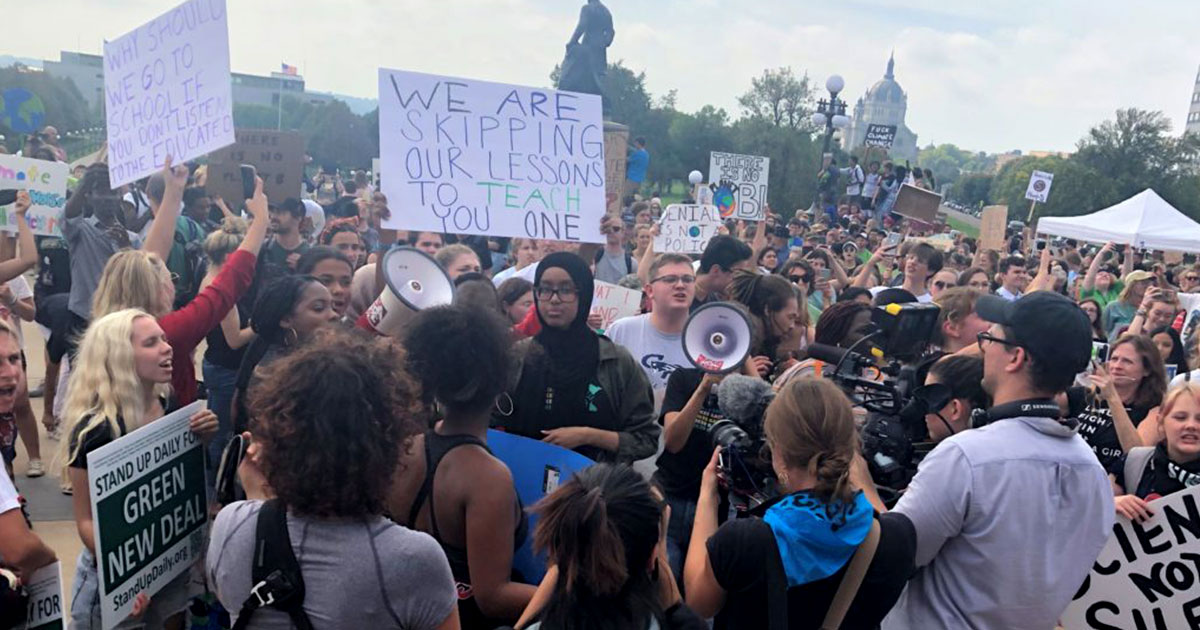 Youth gathered at the State Capitol holding protest signs during the Youth Climate Strike