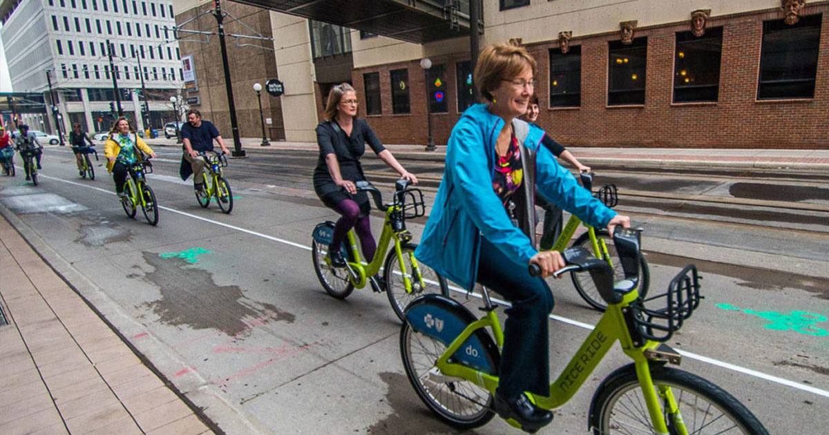 People riding nice ride bikes on Minneapolis city street.