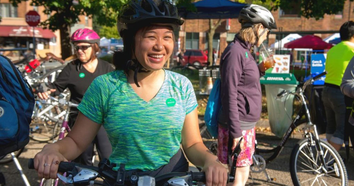 Young woman on a bicycle smiling