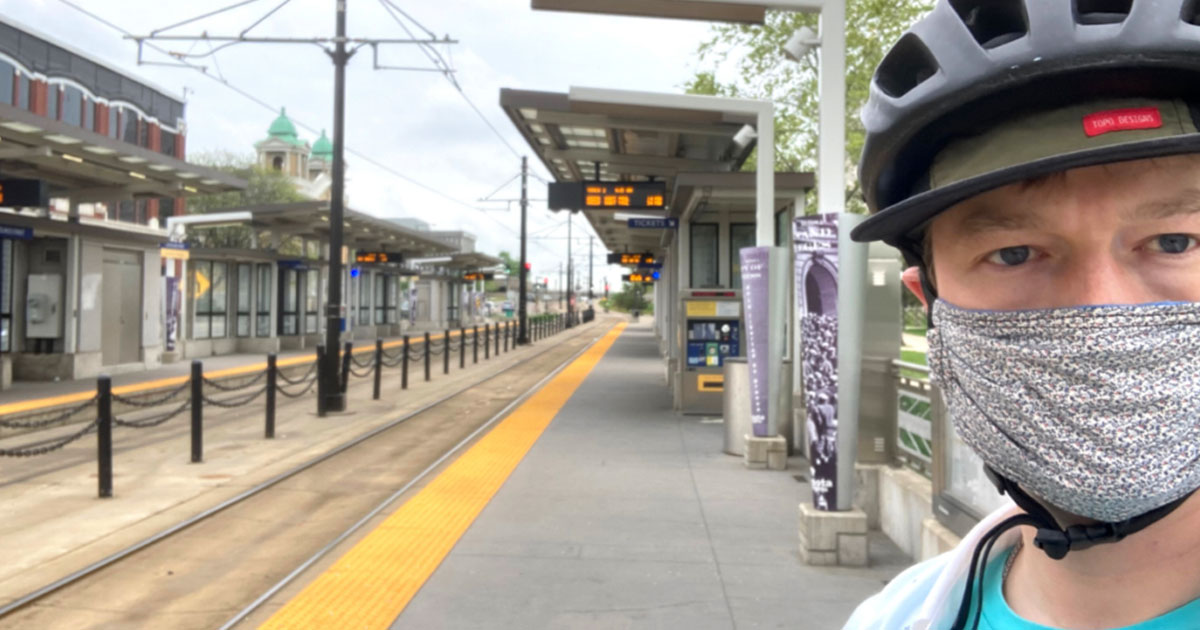 Person taking a selfie picture at a Green Line station in Saint Paul