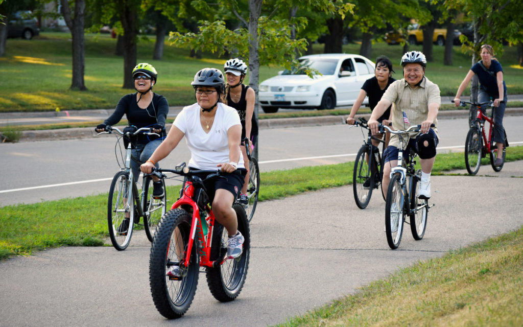 Six people bicycling together on a trail.