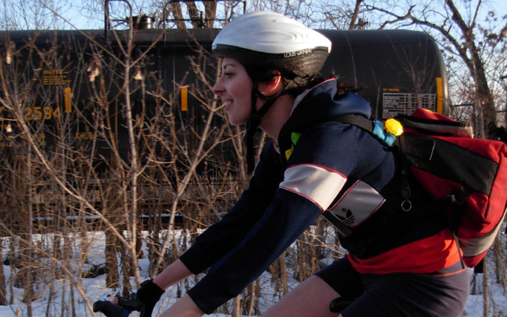 Woman biking on a trail in the winter