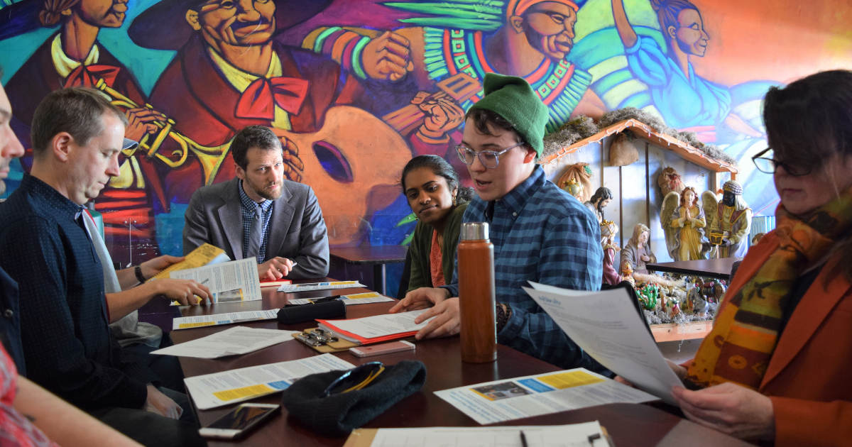 Finn McGarrity, Move Minnesota Community Organizer speaking to a roundtable of attendees at a Minneapolis in-district meeting