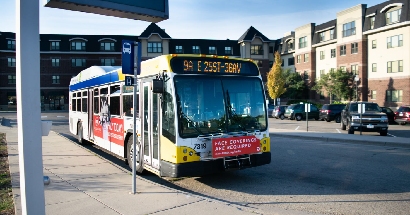 Metro Transit bus in front of multifamily housing in the Twin Cities