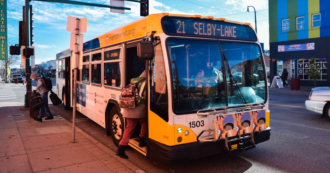 person getting on bus