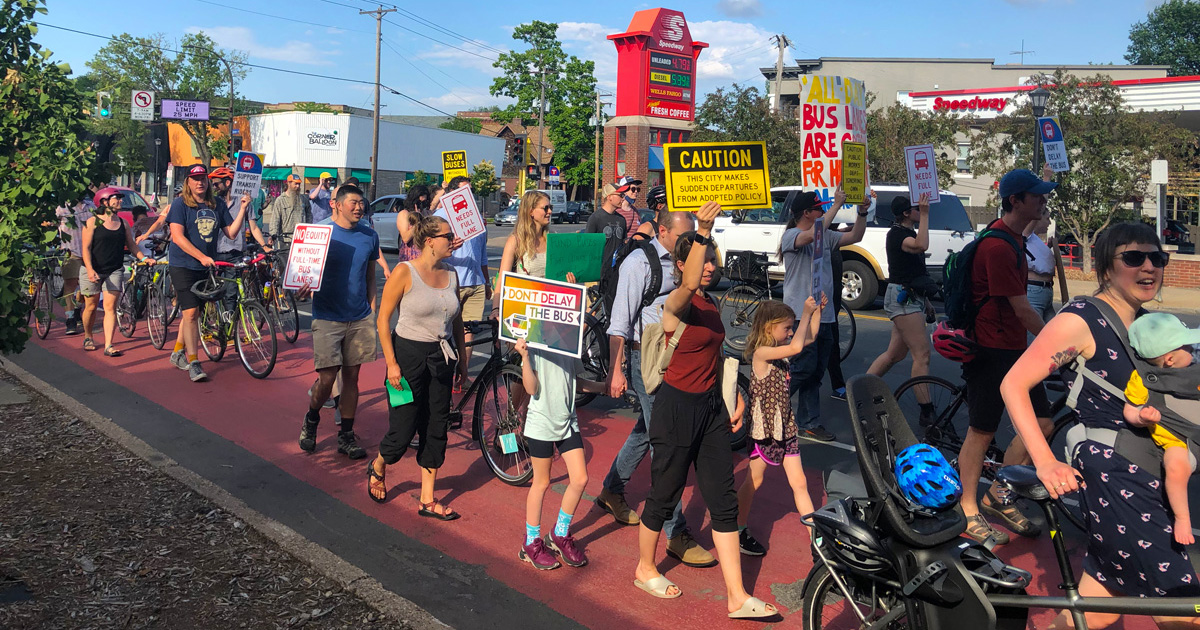 Transit supporters march together for full-time bus lanes on Hennepin Ave South in Minneapolis.