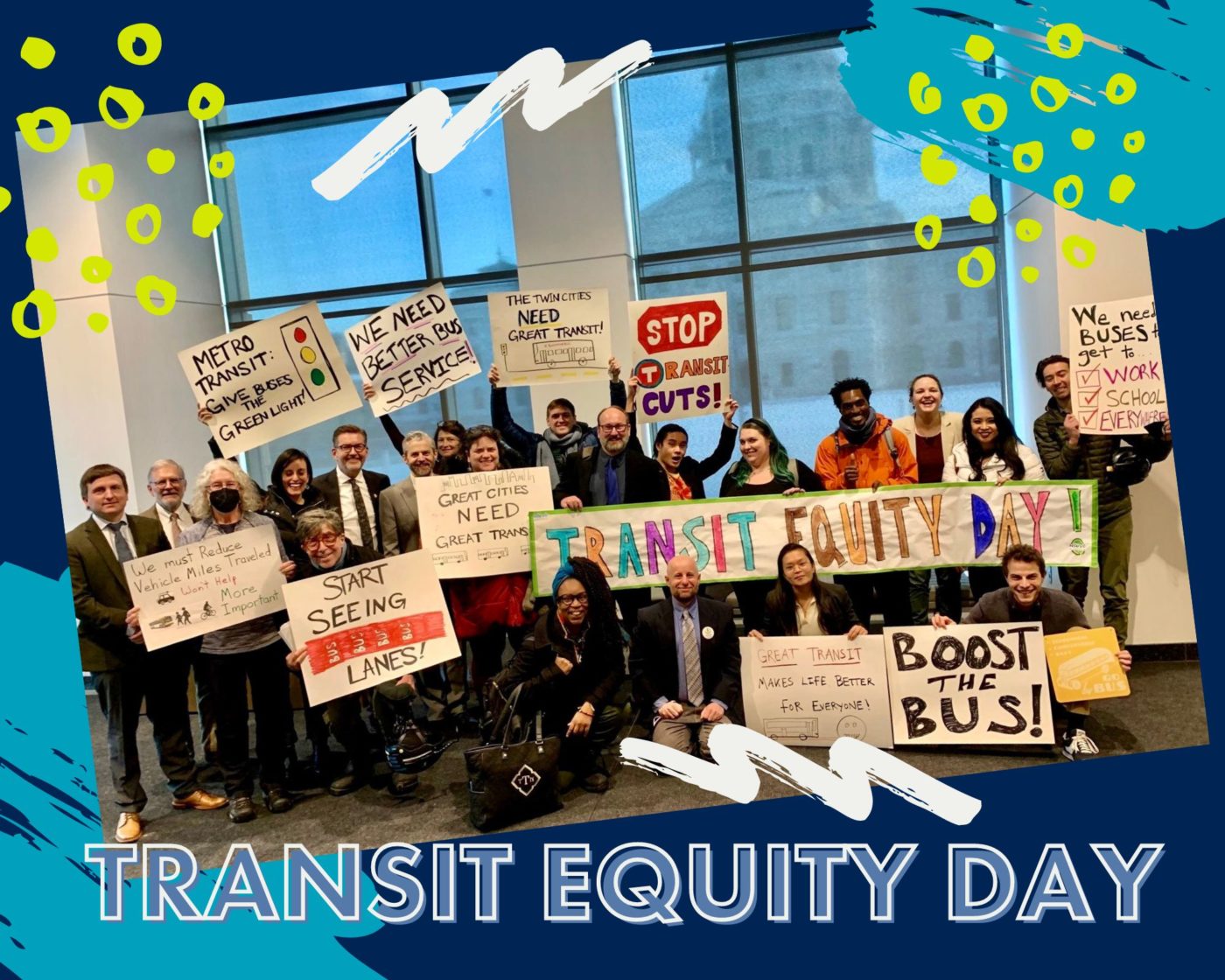 More than 20 smiling people with the background of the state capitol in the window behind them hold up signs that elevate the need for better public transit to create great cities and get people to work, school and other essentials; calls for dedicated signaling and lanes for buses; and an end to transit service cuts!