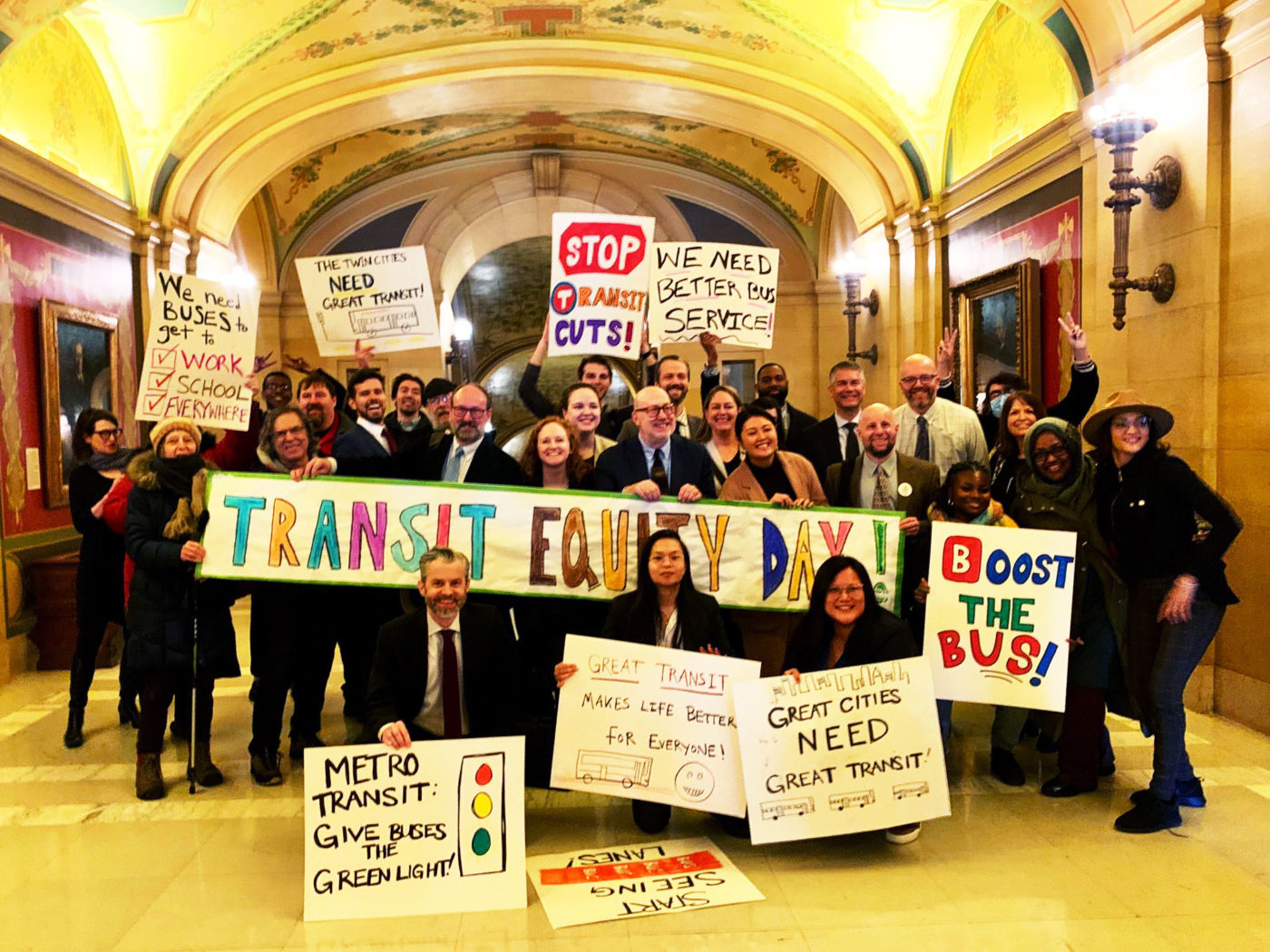 Transit advocates and elected allies rallying together at the State Capitol in 2023.