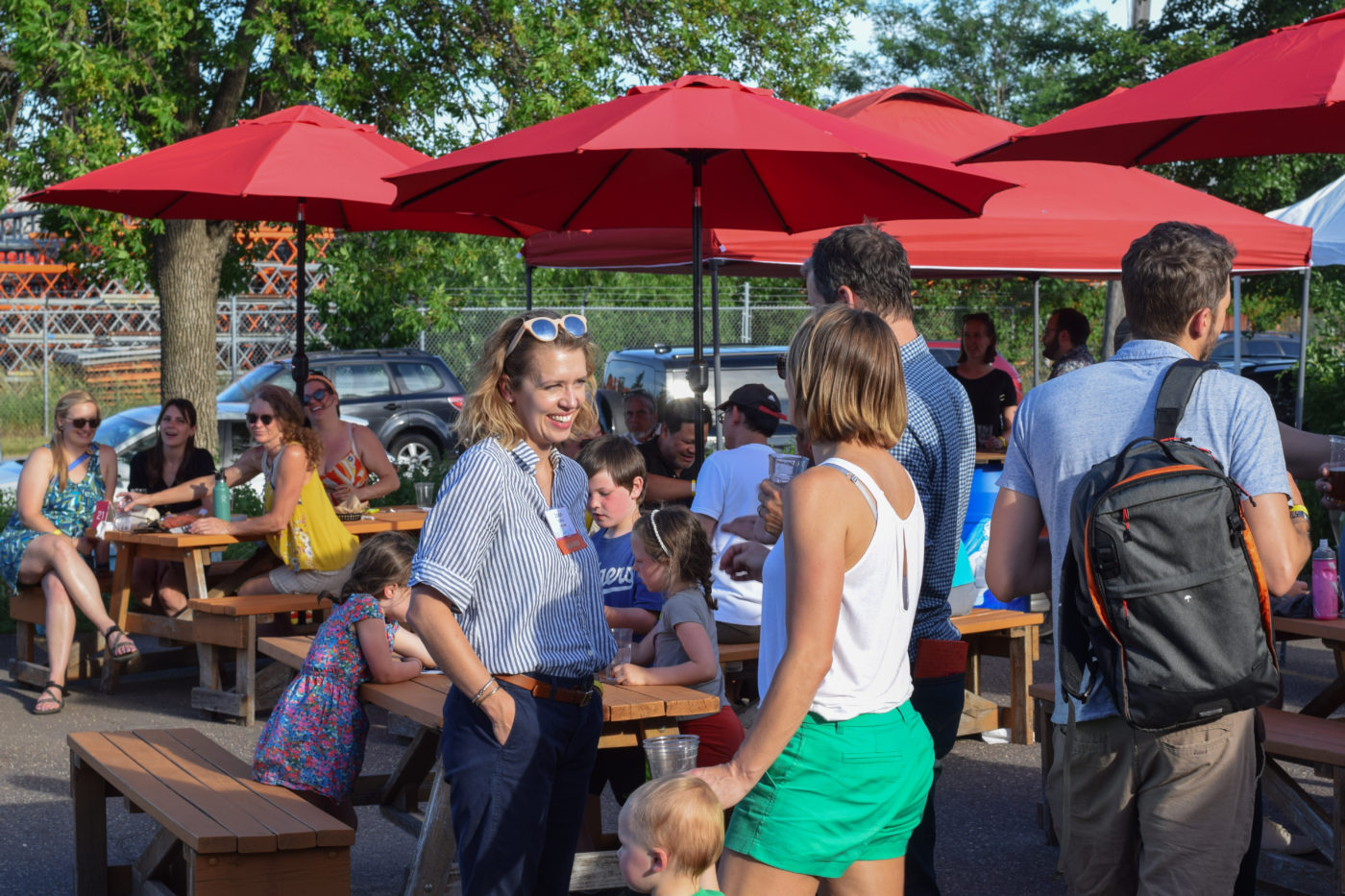 People talking and smiling outdoors at Rock Your Ride 2022