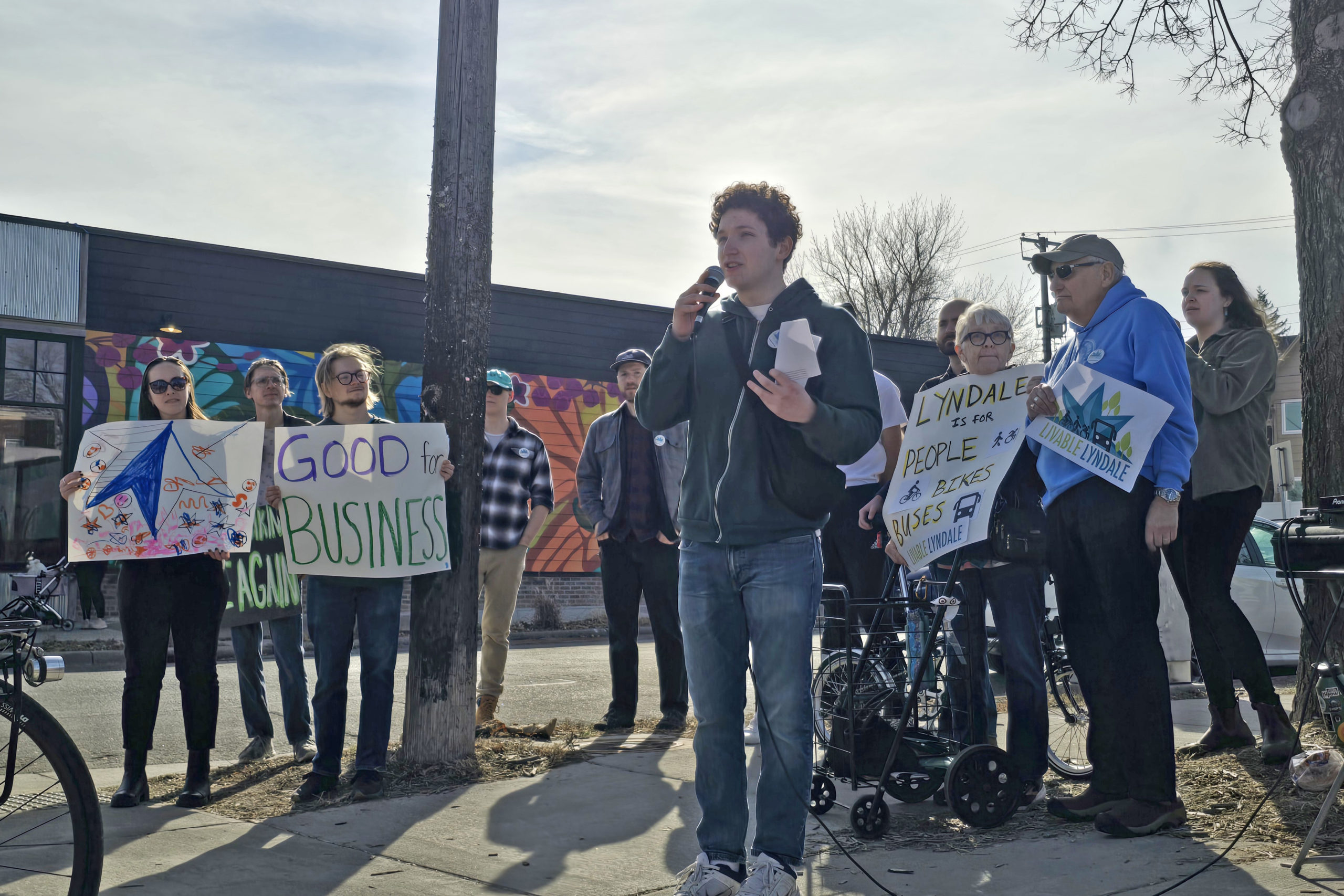 Addressing rally participants, Asa Stanfield, a volunteer with Livable Lyndale, shares why he's involved with the campaign, including the importance of having fast, reliable buses on Lyndale Avenue