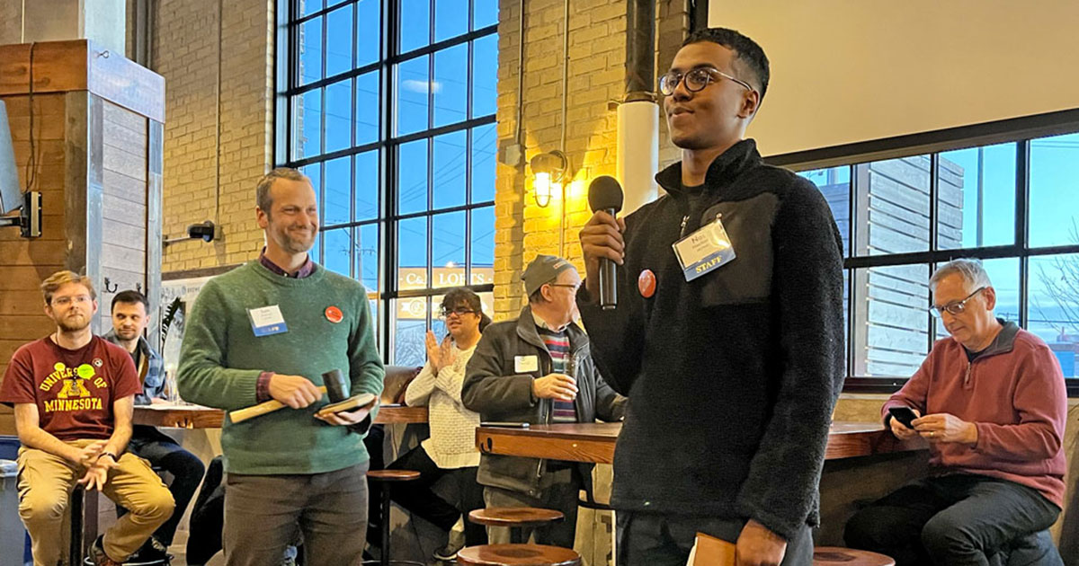 Organizer Nas Nourkadi addresses the crowd of transit allies at a 2024 legislative kickoff event in Saint Paul.