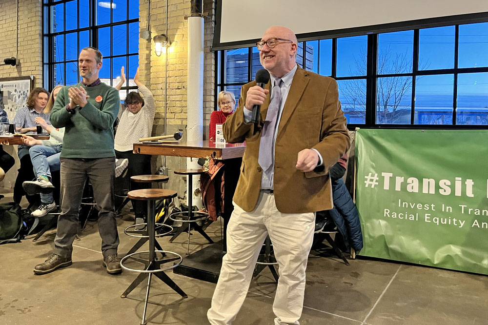 Rep. Frank Hornstein, a longtime transit champion, in the Minnesota House, smiles as he fires up the crowd to continue our collective work for great public transit
