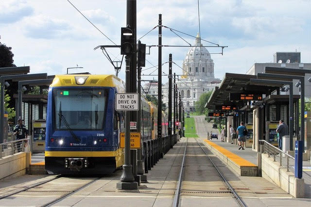 METRO Green Line Light Rail in Saint Paul with State Capitol Building in background.
