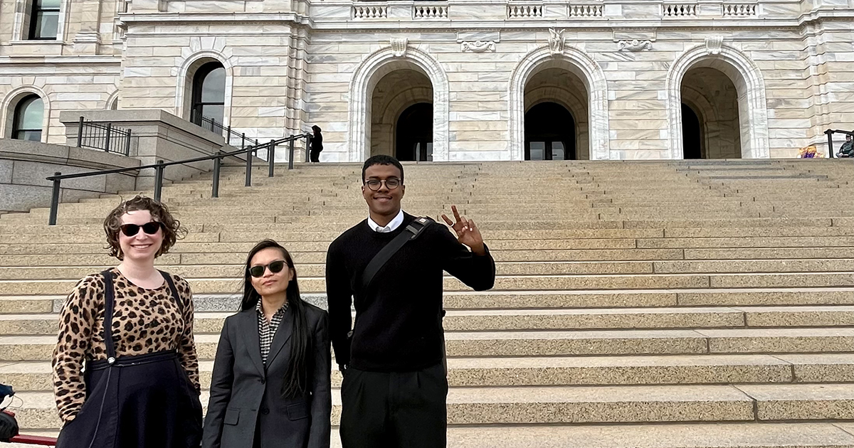 Three Move Minnesota and Move Minnesota Action staff members outside the Minnesota State Capitol