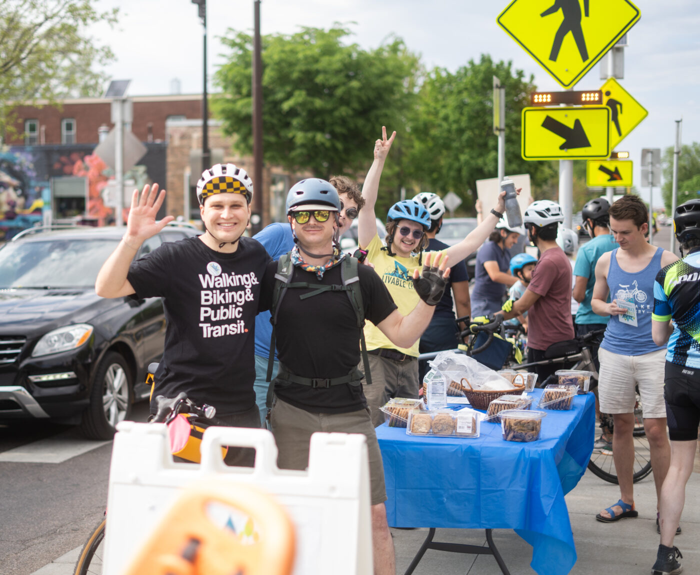 Livable Lyndale volunteers wave during community outreach