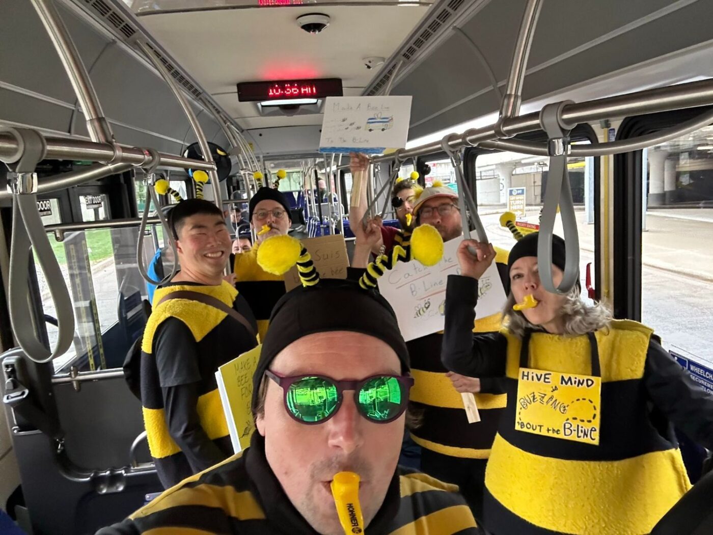 A group of transit riders dressed up like bees for the debut of the METRO B Line