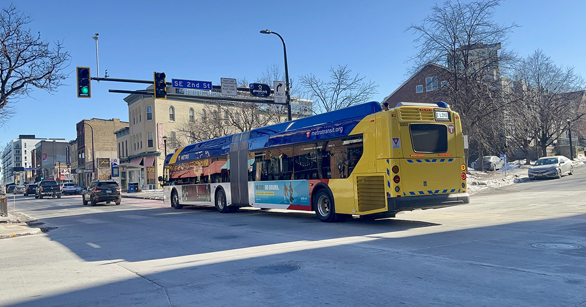 A METRO E Line bus rapid transit bus heads down the street in Minneapolis, Minnesota.