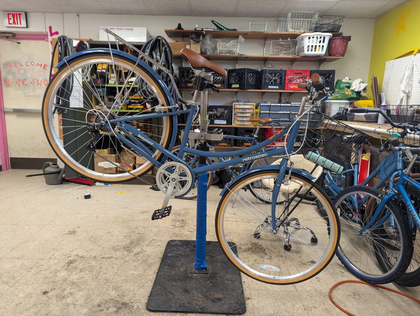 A blue bike mounted on a raised repair station.